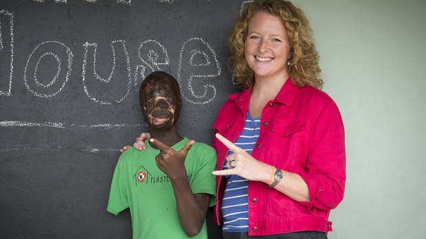 Justin, a teenager who had reconstructive surgery for severe burns, with Sarah Rejman, the Melburnian who founded the Plaster House post surgery centre for disabled kids in Arusha, Tanzania. 