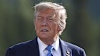 French President Emmanuel Macron looks on as Canadian Prime Minister Mark Carney, center, gestures in front of U.S. President Donald Trump during the family photograph during the G7 Summit