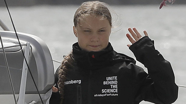 Climate change activist Greta Thunberg waves from the Malizia II boat in Plymouth, England.