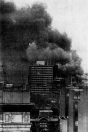 This picture taken from the roof of “The Age”, shows smoke billowing over city buildings shortly after the fire started.