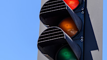 Red traffic lights in the blue sky background