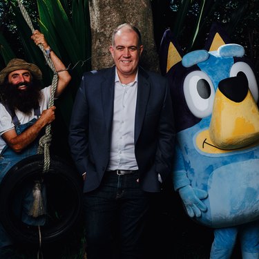 “We upset all sides of politics, simply by holding people to account,” says ABC boss David Anderson, here with Gardening Australia host Costa Georgiadis and Bluey.