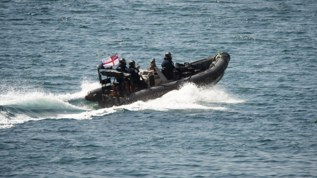 A Royal Marines vessel sails toward the Grace 1 super tanker near the British territory of Gibraltar.