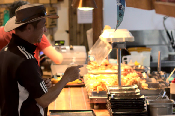 Guests help themselves to tempura fried vegetables, skewers of grilled chicken and other items to power-up their lunch.