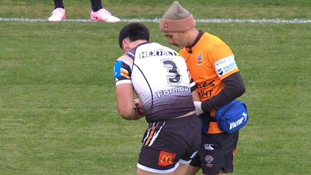 Taylan May is helped off the field after dislocating his shoulder.