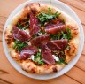 Bresaola pizza with onion, goat's cheese and rocket.