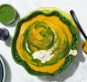 Roast pumpkin soup swirled with spinach puree and cream.