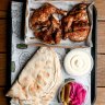 Whole chicken plate with pickles, pita and toum (tangy garlic sauce).