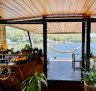 Oh Buoy, a 1970s houseboat, restored from its dilapidated state by hand.