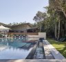 The 25-metre pool is surrounded by cabanas and a rainforest backdrop.