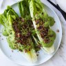 Green goddess dressing drizzled over lettuce with bonus bacon bits.