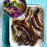 Barbecued sausages with red cabbage and mustard salad.