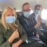 Qantas chief Alan Joyce wears a face mask on board a flight last month.