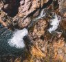 Visitors relaxing in the pristine natural waterfall and plunge pool at Maguk, in the south of Kakadu National Park.