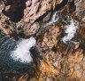 Visitors relaxing in the pristine natural waterfall and plunge pool at Maguk, in the south of Kakadu National Park.