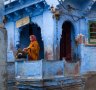 Indian woman standing on her terrace in Jodhpur, India's Blue city.