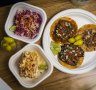 The taco plate with two sides, corn and slaw.