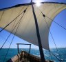 The dhow's sail full of breeze. 