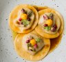 Duck ravioli with pomegranate sauce.