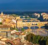 Florence, with its medieval Ponte Vecchio stone arched bridge over the Arno River.