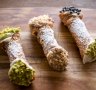 From left: Pistachio, Nutella and classic cannoli piped with ricotta-based fillings and dipped in crushed nuts and/or chocolate chips.