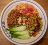 The dao xiao special biang noodle dish with pork mince, scrambled egg, potato, carrot and celery stir-fry and Asian greens.