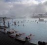 Guests relax in geothermal seawater in the main lagoon at the Blue Lagoon spa in Grindavik, Iceland, 