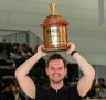 Anthony Douglas holds his trophy aloft at the World Barista Championship at the Melbourne Convention Centre. 