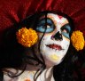 A woman dressed as Mexico's iconic 'Catrina' awaits the start of the grand procession of the Catrinas, part of the Day of the Dead celebrations in Mexico City.