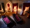 In this picture taken Oct. 9, 2016, two coffins are lit before a photo shoot in Bran Castle, in Bran, Romania. Airbnb has launched a contest to find two people to stay overnight in the castle on Halloween, popularly known as Dracula?s castle because of its connection to the cruel real-life prince Vlad the Impaler, who inspired the legend of Dracula. (AP Photo/Andreea Alexandru)