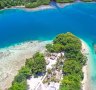 The route to Bougainville takes you over the brilliant blue of the Pacific, dotted with cayes and atolls.