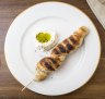 Stockbrot (bread on a stick) served with creme fraiche and pumpkin seed oil.