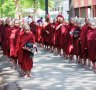 Young buddhist novices walk to collect alms and offerings in the monastery of Maha Gandhayon Kyaung.