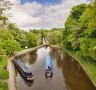 Narrowboats in the Llangollen Canal, built by Thomas Telford, manoeuvering before crossing the Chirk Aqueduct.