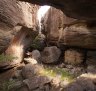Aboriginal artist Wilfred Nawirridj studies rock art in a vast cave at Injalak Hill in Arnhem Land.