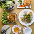 Spring rolls, sugar cane prawns, fresh rice pastry and accompanying fresh herbs and dipping sauce at Phu Quoc, Cabramatta. 