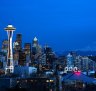 Seattle skyline with the Space Needle in the foreground and Mount Rainier in the distance.