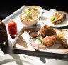 Smoked chicken, boudin sausage, sauces and coleslaw at Fancy Hank's new fancy digs.