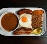 Bandeja paisa platter with braised red beans, chicharron (fried pork belly), minced beef, Colombian chorizo,  plantain, avocado, arepa, fried egg and rice.