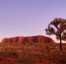 Uluru rises out of the desert, towering 348 metres above the surrounding plain.