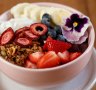 Acai bowl with banana, berries, coconut and granola.