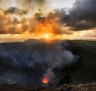 The active volcano at Mount Yasur, erupting at sunrise. 