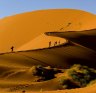 Tourists climbing Sossusvlei dune, Naukluft National Park, Namibia.