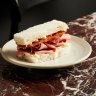 Fugazzi's signature mortadella and salami finger sando with mayo, pickled shallot and pecorino.