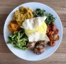 Load up your plate with a selection of curries, rice, vegies and other dishes.