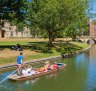 Tourists punting on the river Cam, Cambridge.