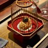 "Sea treasure" ball presented in a wooden birdcage.