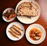 Clockwise from top right: House-baked sourdough bread with mussels
escabeche, anchovies and pickles.