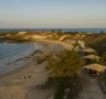 Banubanu Beach Retreat sits on a crescent-shaped white sand beach, lined with safari tents. 