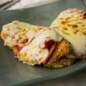 Chicken parmigiana with roast capsicum and tomato salad. 